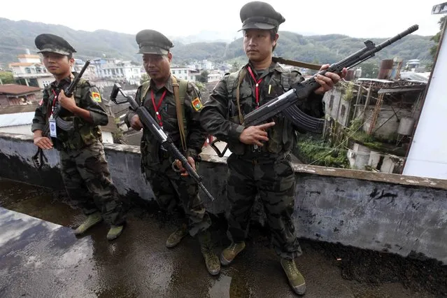 In this October 29, 2013, file photo, soldiers of the Kachin Independence Army (KIA) stand on guard in Laiza, a border town of China and Myanmar, Kachin State, Myanmar. The Kachin Independence Army claims to have shot down a helicopter belonging to the government’s military Monday, May 3, 2021, in the course of heavy fighting over a strategic position. (Photo by Khin Maung Win/AP Photo/File)