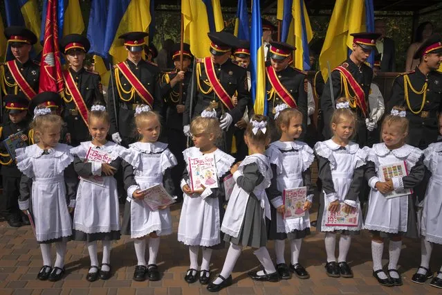 Cadets and schoolgirls attend a ceremony on the first day of school at a cadet lyceum in Kyiv, Ukraine, Monday, September 4, 2023. (Photo by Efrem Lukatsky/AP Photo)