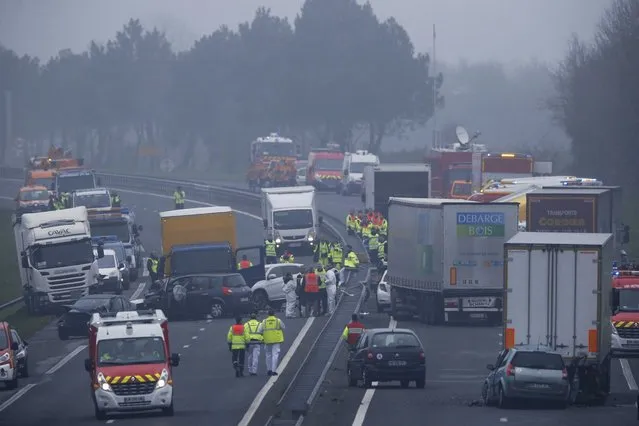 French rescue services work at the scene of an accident involving fifty vehicles which crashed due to fog on the road between La Roche-sur-Yon and Sables-d'Olonne, France, that killed five and injured more than forty, December 20, 2016. (Photo by Stephane Mahe/Reuters)