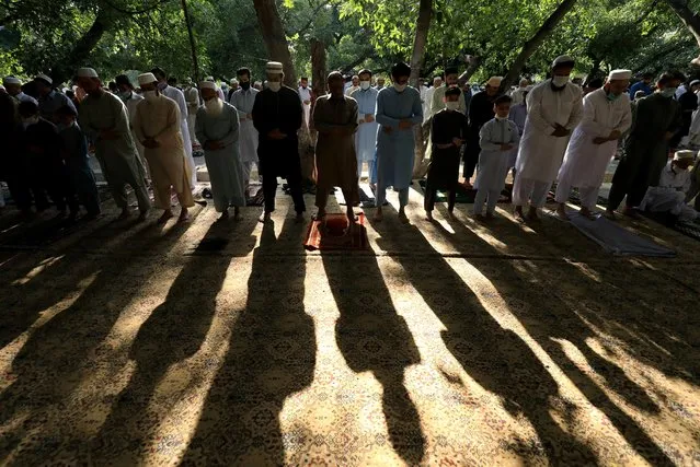 Pakistani Muslims celebrate Eid al-Fitr prayers to mark the end of the holy fasting month of Ramadan, as the outbreak of the coronavirus disease (COVID-19) continues in Peshawar, Pakistan on May 13, 2021. (Photo by Fayaz Aziz/Reuters)
