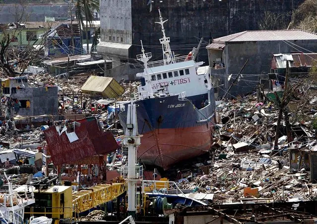 A cargo ship that washed ashore is seen on Monday in Anibong town in Tacloban. (Photo by Romeo Ranoco/Reuters)
