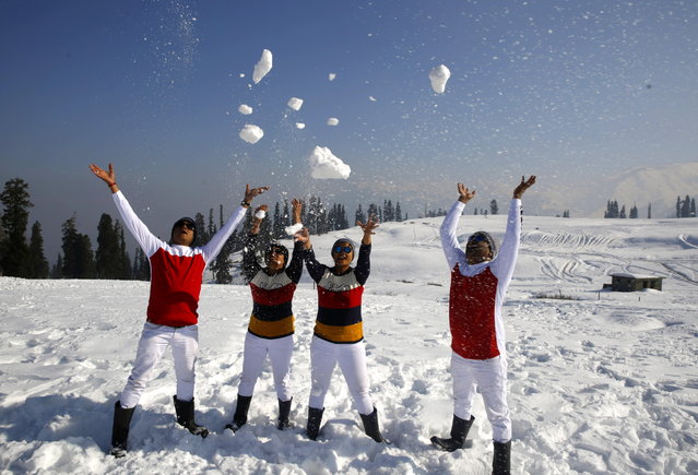 Indian tourists play with snow at Kongdoori tourist resort in Gulmarg north of Kashmir, some 60km from Srinagar, the summer capital of Indian Kashmir, 31 December 2018. Gulmarg is a popular ski resort in the north Indian region and every year witnesses a large influx of tourists from India and outside the country around this time of the year. (Photo by Farooq Khan/EPA/EFE)