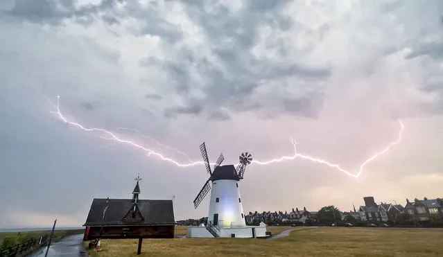 The picture dated June 12, 2023 shows lightning over Lytham Windmill in Lancashire, North West England last night. (Photo by John Threlfall/Bav Media)