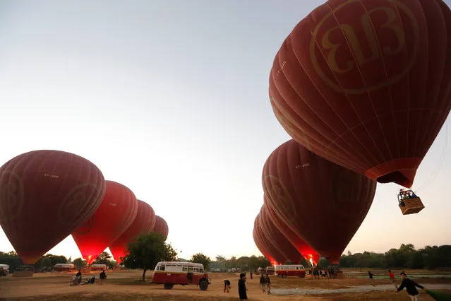Hot-air balloons carrying tourists take off before sunrise over ancient city Bagan January 11, 2017. (Photo by Soe Zeya Tun/Reuters)