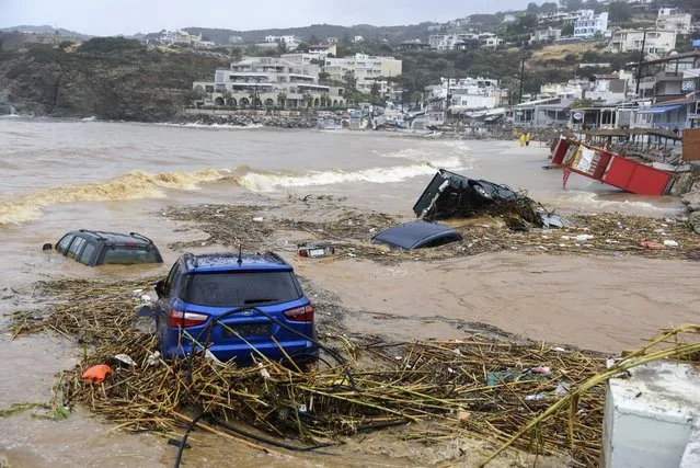 Cars submerged in water, following heavy thunderstorms, in the village of Agia Pelagia, on the island of Crete, Greece, Saturday, October 15, 2022. It has been reported that at least one person has died with others missing due to the severe flooding. (Photo by Harry Nakos/AP Photo)