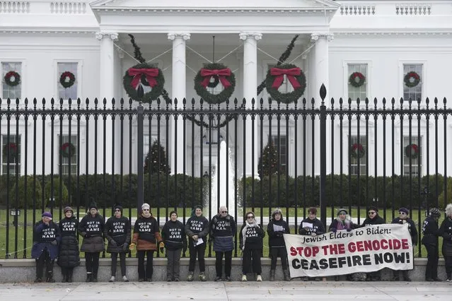 Activists with Jewish Voice for Peace, gather to protest the Israel-Hamas war in Gaza and chain themselves to the fence outside the White House, Monday, December 11, 2023, in Washington. (Photo by Susan Walsh/AP Photo)