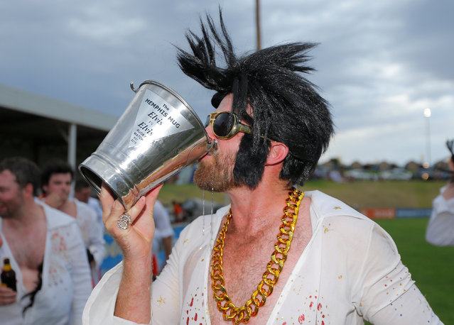 An amateur rugby player dressed as Elvis Presley drinks from the Memphis Mug trophy after the match between the Blue Suede Shoes and the Reddy Teddies at the 25th annual Parkes Elvis Festival in the rural Australian town of Parkes, west of Sydney, Australia January 13, 2017. (Photo by Jason Reed/Reuters)