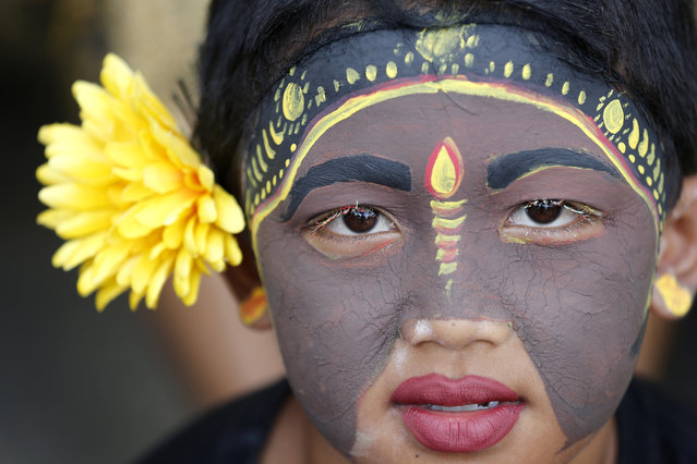 A Balinese youth participates in the Hindu ritual of “Grebeg” at the Tegalalang village in Bali, Indonesia, Wednesday, January 30, 2019. In this biannual ritual, young participants paint their bodies with colorful paint and parade around their village to ward off evil spirits. (Photo by Firdia Lisnawati/AP Photo)