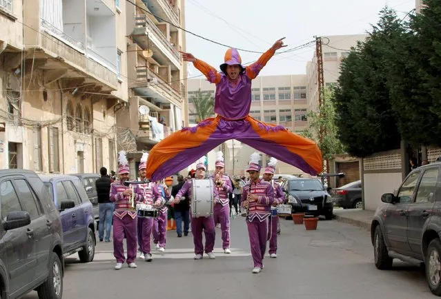 A dancer jumps during a parade celebrating the coming of spring in Tripoli, north Lebanon April 17, 2015. (Photo by Omar Ibrahim/Reuters)