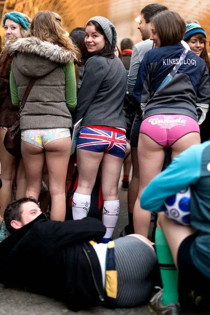 Participants in the13th annual International “No Pants Subway Ride” pose for a photograph at Paddington underground station in London, on January 12, 2014. (Photo by Leon Neal/AFP Photo)