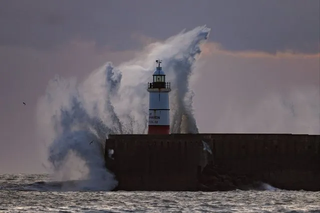 Waves crash over Newhaven breakwater and light house on December 21, 2023 in Newhaven, England. Met Office has issued a yellow warning for wind as Christmas travel is threatened by Storm Pia bringing 80mph gusts to parts of the UK. (Photo by Dan Kitwood/Getty Images)