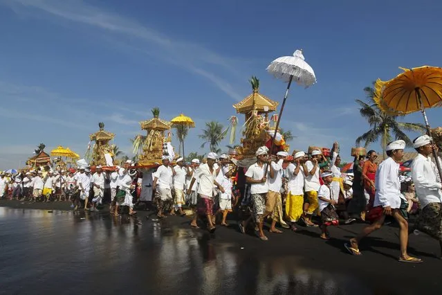 Balinese Hindus carry Pratimas, or symbols of God, during Melasti, a purification ceremony, ahead of the holy day of Nyepi, in Gianyar on the Indonesian resort island of Bali, March 6, 2016. (Photo by Roni Bintang/Reuters)