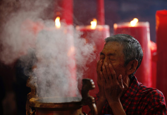 A man prays during Lunar New Year celebrations at Dharma Bhakti temple in Jakarta, Indonesia January 28, 2017. (Photo by Darren Whiteside/Reuters)