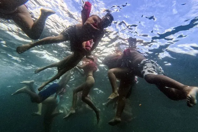 Tourists snorkel near a shipwreck off Cubagua Island, Venezuela, Sunday, January 14, 2024. (Photo by Matias Delacroix/AP Photo)