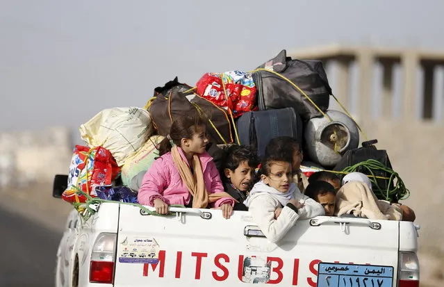 Children ride on the back of a pick-up truck with their luggage as they flee Saudi-led air strikes in Sanaa, April 6, 2015. (Photo by Khaled Abdullah/Reuters)