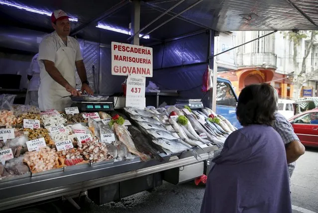 Pople buy seafood in a street market in downtown Montevideo, Uruguay March 9, 2016. (Photo by Andres Stapff/Reuters)