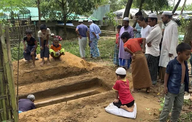 A grave is being prepared to bury Mohibullah, an international representative of ethnic Rohingya refugees, at the Rohingya refugee camp in Kutupalong, Bangladesh, Thursday, September 30, 2021. Mohibullah, who was in his 40s, was a teacher who emerged as a key refugee leader and a spokesman representing the Muslim ethnic group in international meetings, was shot to death in a camp in Bangladesh by unknown gunmen late Wednesday, police said. (Photo by Shafiqur Rahman/AP Photo)