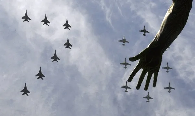 MiG-29 and Su-25 military jets fly in formation above Red Square during the Victory Day parade in Moscow, Russia, May 9, 2015. (Photo by Reuters/Host Photo Agency/RIA Novosti)