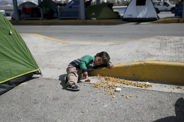 A boy plays with his toy truck at a makeshift camp for refugees and migrants at the port of Piraeus, near Athens, Greece March 24, 2016. (Photo by Alkis Konstantinidis/Reuters)
