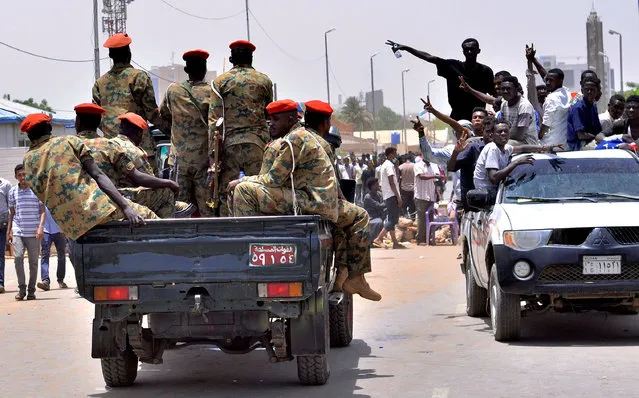 Sudanese demonstrators cheer as they drive towards a military vehicle, after Sudan's Defense Minister Awad Mohamed Ahmed Ibn Auf said that President Omar al-Bashir had been detained “in a safe place” and that a military council would run the country for a two-year transitional period, near Defence Ministry in Khartoum, Sudan April 11, 2019. (Photo by Reuters/Stringer)