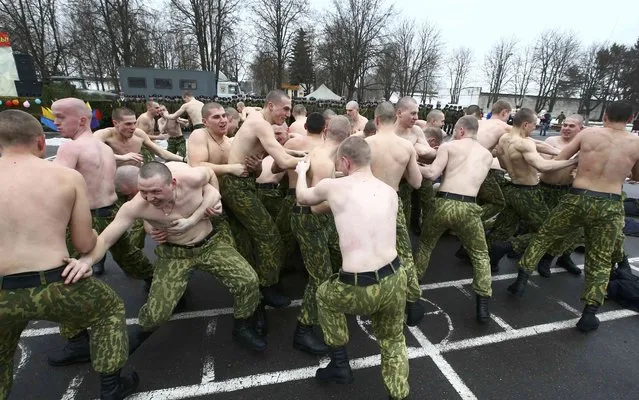 Servicemen of the Belarussian Interior Ministry's special forces unit charge at each other during a traditional fighting game to celebrate Maslenitsa, a pagan holiday marking the end of winter  celebrated with pancake eating and shows of strength, at their base in Minsk, Belarus February 19, 2017. (Photo by Vasily Fedosenko/Reuters)