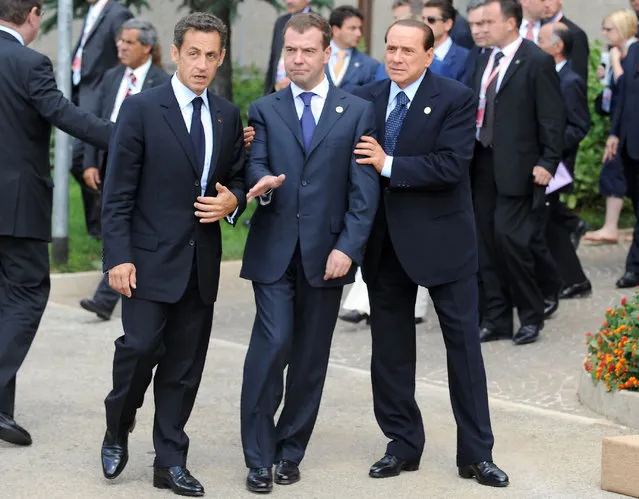 (L to R)  French President Nicolas Sarkozy, Russian President Dmitri Medvedev, and Italian Prime Minister Silvio Berlusconi arrive to pose for a family photo at the Group of Eight (G8) summit in L'Aquila, central Italy, on July 8, 2009. Group of Eight leaders kick off talks today on issues ranging from the global financial crisis to climate change to the situations in Iran and Xinjiang, China. (Photo by Peer Grimm/AFP Photo)