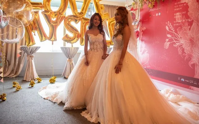 Lesbian couple Amber (L) and Huan Huan, wait to take part in a wedding event to raise HIV awareness a day after Taiwan's parliament voted to legalise same-s*x marriage, on May 18, 2019 in Taipei, Taiwan. Taiwan yesterday became the first country in Asia to legalise same-s*x marriage after lawmakers voted to allow same-s*x couples full legal marriage rights, including areas in taxes, insurance and child custody. Thousands of gay rights supporters gathered outside the parliament building in the nation's capital as the result was announced. The bill will go into effect on May 24. (Photo by Carl Court/Getty Images)