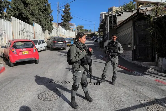 Israeli border police officers stand guard at the scene of a stabbing attack in east Jerusalem, Wednesday, December 8, 2021. An Israeli woman was stabbed and lightly wounded in Sheikh Jarrah neighborhood in east Jerusalem on Wednesday. The suspect, a Palestinian female minor, fled the scene and was later arrested inside a nearby school, police said. (Photo by Mahmoud Illean/AP Photo)