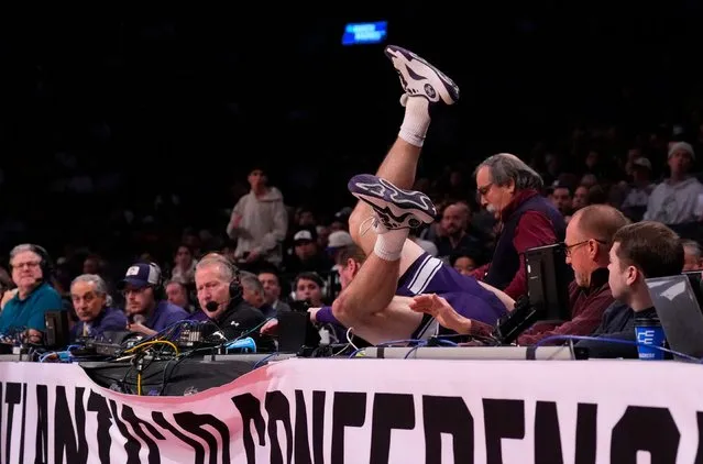 Northwestern Wildcats guard Brooks Barnhizer dives into the scorer's table against the Florida Atlantic Owls in the first round of the 2024 NCAA Tournament at the Barclays Center on March 22, 2024. (Photo by Robert Deutsch/USA TODAY Sports)