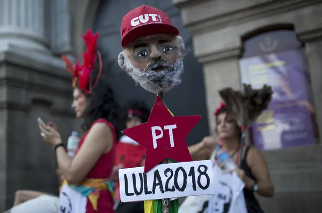 A mask in the likeness of Brazil's former President Luiz Inacio Lula da Silva stands before the start of the “Out Temer” carnival street party in Rio de Janeiro, Brazil, Friday, February 24, 2017. (Photo by Silvia Izquierdo/AP Photo)