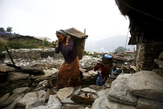 Earthquake victims carry goods recovered from the collapsed houses on bamboo baskets at Barpak village in Gorkha district May 20, 2015. (Photo by Navesh Chitrakar/Reuters)