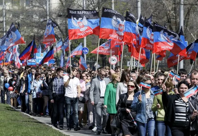 People carry flags of the self-proclaimed Donetsk People's Republic as they attend a rally dedicated to the second anniversary of republic's founding in Donetsk, Ukraine, April 9, 2016. (Photo by Alexander Ermochenko/Reuters)