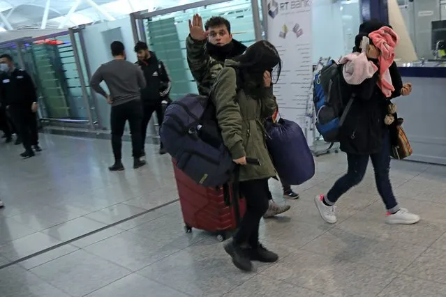 Iraqi migrants arrive to the airport in Irbil, Iraq, early Friday, November 26, 2021. 170 Iraqi nationals returned home Friday from Belarus in a repatriation process that came after tensions at Poland's eastern border, where thousands of migrants became stuck in a cold and soggy forest. (Photo by Hussein Ibrahim/AP Photo)