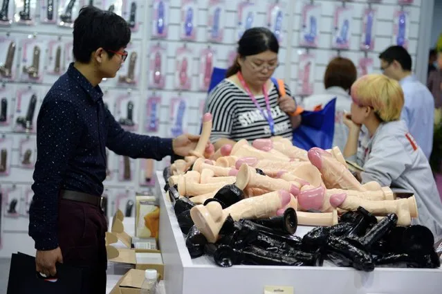 A visitor checks an adult toy during the 2016 Shanghai International Adult Toys and Reproductive Health Exhibition in Shanghai on April 14, 2016. 
The exhibition will last four days from April 14 to 17. (Photo by AFP Photo/Stringer)