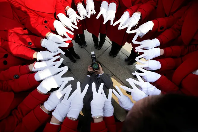 Attendants serving delegates from a hotel pose for a photo at Tiananmen Square as delegates attend a meeting during the annual session of China's parliament, the National People's Congress (NPC), in Beijing, China March 4, 2017. (Photo by Jason Lee/Reuters)