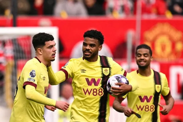 Burnley's Swiss striker #25 Zeki Amdouni (L) celebrates with teammates after scoring his team first goal during the English Premier League football match between Manchester United and Burnley at Old Trafford in Manchester, north west England, on April 27, 2024. (Photo by Oli Scarff/AFP Photo)