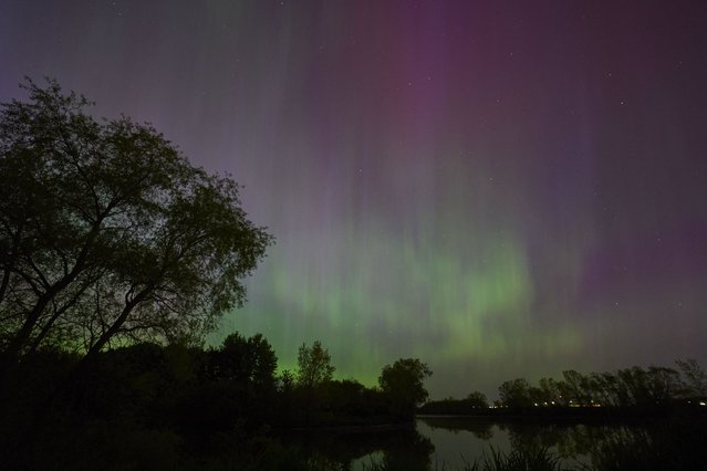 Northern lights or aurora borealis illuminate the night sky near London, Ontario, during a geomagnetic storm on May 10, 2024. (Photo by Geoff Robins/AFP Photo)