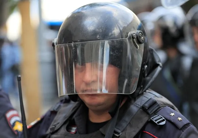 A law enforcement officer stands guard during a rally calling for opposition candidates to be registered for elections to Moscow City Duma, the capital's regional parliament, in Moscow, July 27, 2019. The detentions came around a protest to demand that opposition members be allowed to run in a local election. Authorities had declared it illegal and sought to block participation, but several thousand people turned up anyway in one of the longest and most determined protests of recent years. (Photo by Maxim Shemetov/Reuters)