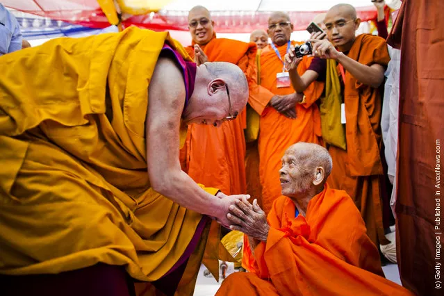 His Holiness, the Dalai Lama greets an elderly Buddhist monk at a multi-faith prayer gathering at Gandhi Smriti prior to his keynote speech at the Global Buddhist Congregation on November 30, 2011 in New Delhi, India. The Dalai Lama is attending the four day Global Buddhist Congregation, which will be attended by religious leaders from 32 countries. The aim of the Congregation is to set up an international forum that will aim to promote global peace, stability and prosperity through collective action, while rejecting prejudices, exploitation and violence