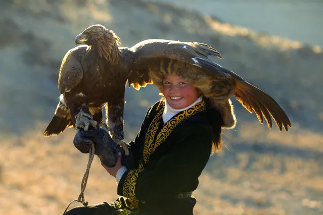 13 year old Ashol Pan with her eagle – Despite her young age, Ashol had the amazing ability to control and be able to caress her eagle, almost as if she had been with it for years. (Photo by Asher Svidensky/Caters News)