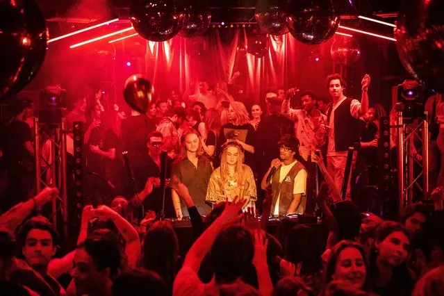Partygoers at Chicago Social Club during a protest against night clubs closure, in Amsterdam, Netherlands, late 12 February 2022 (issued 13 February 2022). Several clubs in Amsterdam took part in the protest, reopening against the rules to draw attention to the long-term closure that nightlife is experiencing due to the Covid-19 measures enforced by the Dutch government. (Photo by Ramon van Flymen/EPA/EFE)