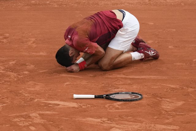 Serbia's Novak Djokovic slipped and fell during his fourth round match of the French Open tennis tournament against Argentina's Francisco Cerundolo at the Roland Garros stadium in Paris, Monday, June 3, 2024. (Photo by Christophe Ena/AP Photo)