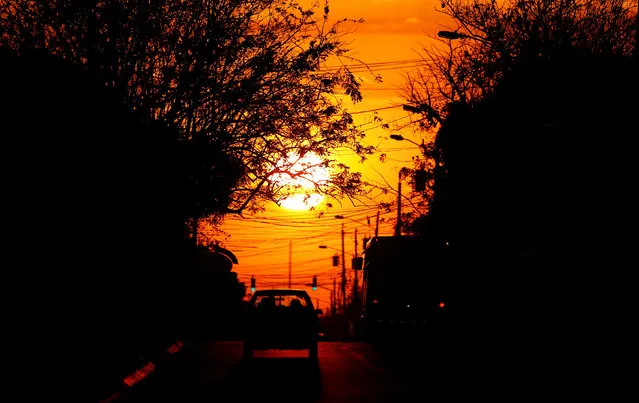 Cars drive on a road during sunset in San Jose, Costa Rica February 20, 2017. (Photo by Juan Carlos Ulate/Reuters)