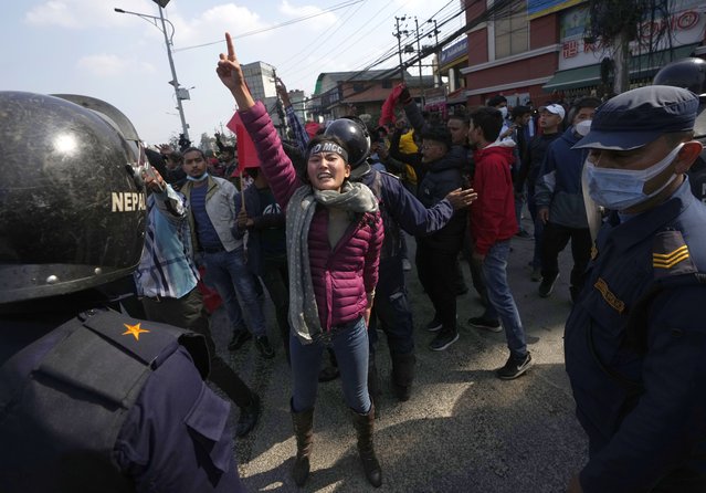 Nepalese protesters opposing a proposed U.S. half billion dollars grant for Nepal shout slogans outside the parliament in Kathmandu, Nepal, Wednesday, February 16, 2022. (Photo by Niranjan Shreshta/AP Photo)