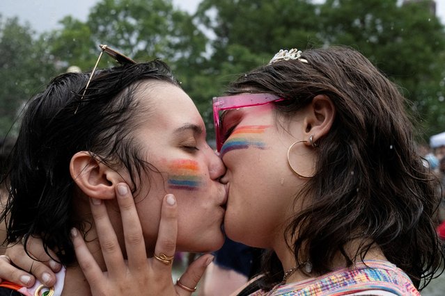 Revelers celebrate Pride in the fountain in Washington Square Park in New York City on June 30, 2024. (Photo by Stephanie Keith/Reuters)