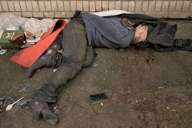 The lifeless body of a man with his hands tied behind his back lies on the ground in Bucha, Ukraine, Sunday, April 3, 2022. (Photo by Vadim Ghirda/AP Photo)