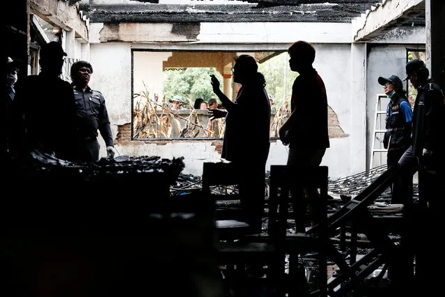 Forensic experts inspect a burnt building at the Pitakkiat Wittaya School in the northern province of Chiang Rai, Thailand, May 23, 2016. (Photo by Athit Perawongmetha/Reuters)