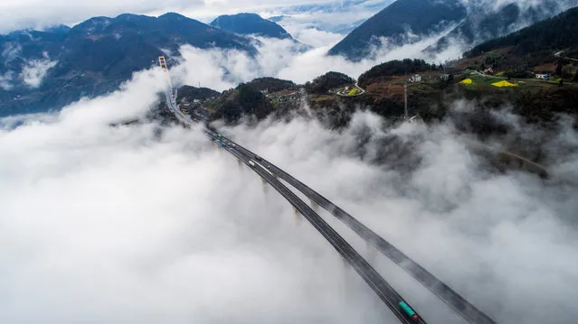 Photo taken on April 4, 2017 shows the cloud-wrapped Siduhe Bridge in Enshi, central China's Hubei Province. (Photo by Wen Lin/Xinhua/Barcroft Images)