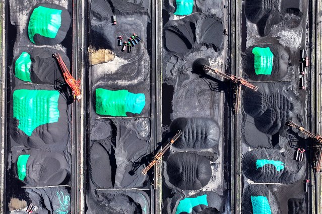 Coal is sorted into piles at a coal yard at the port in Ningbo, in China’s eastern Zhejiang province on July 16, 2024. (Photo by AFP Photo/China Stringer Network)