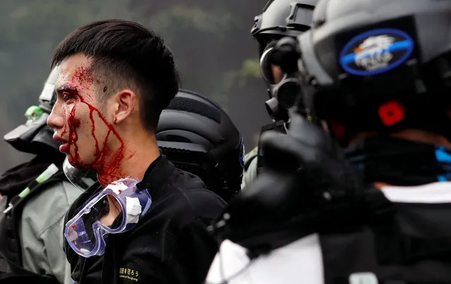 Police detain protesters who attempt to leave the campus of Hong Kong Polytechnic University (PolyU) during clashes with police in Hong Kong, China on November 18, 2019. (Photo by Tyrone Siu/Reuters)